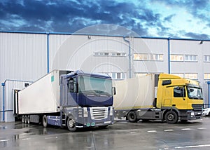 Unloading cargo truck at warehouse building