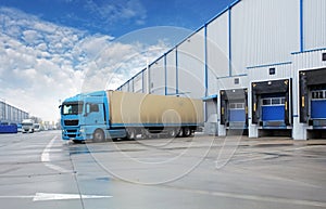 Unloading cargo truck at warehouse building