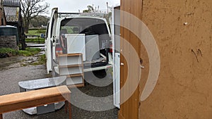 Unloading a home removals van truck full of furniture