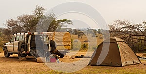 Unloading parked jeep at camp on safari