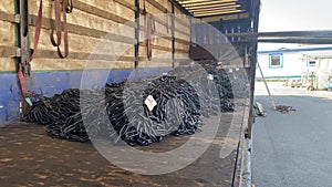 Unloading of round link chains from the truck using forklift. Operations with cargo