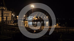 Unloading sulfur in trading seaport at night in Odessa, Ukraine.