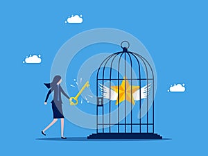 Unlock success in work. Businesswoman uses a key to release the stars in the cage.