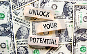 Unlock your potential symbol. Concept words Unlock your potential on wooden blocks. Dollars. Beautiful background from dollar