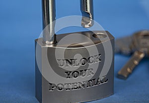 Unlock your potential text engraved on padlock with dark blue background. Motivational concept