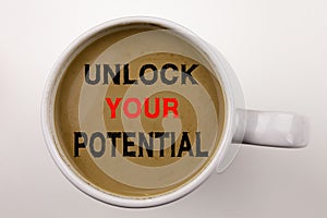 Unlock Your Potential Writing text in coffee in cup. Business concept for Self-Development Improvement on white background with co