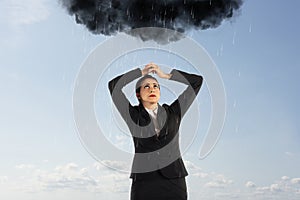 Unlucky businesswoman with a black cloud full of rain over her head