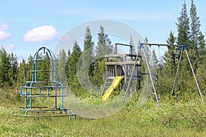 An unmaintained abandoned playground at a campsite