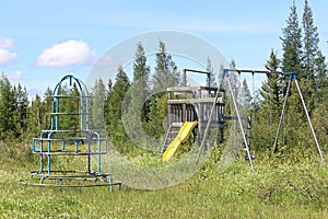 An unmaintained abandoned playground at a campsite photo