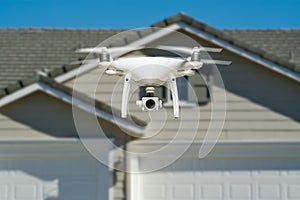 Unmanned Aircraft System Quadcopter Drone In The Air Near House photo
