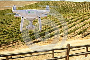 Unmanned Aircraft System UAV Quadcopter Drone In The Air Over Grape Vineyard Farm