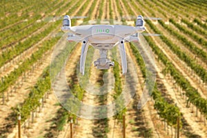 Unmanned Aircraft System UAV Quadcopter Drone In The Air Over Grape Vineyard Farm