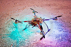 Unmanned quadrocopter landed on snow in winter photo