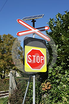 Unmanned railroad crossing with  St. Andrew`s cross and solar power lights