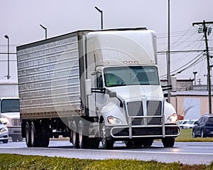 An Unmarked Tractor Trailer Leads Traffic On A Wet Day