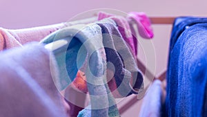 Mismatched socks drying on a rack, daytime. Depicting laundry day, cleaning, house chores and missing sock pairs