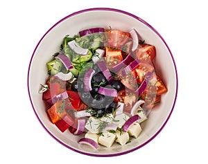 Unmixed ingredients of greek salad in glass bowl isolated on white background