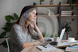 Unmotivated Caucasian woman distracted from studying thinking