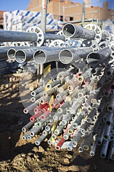 Unmounted scaffolding elements piled at construction site