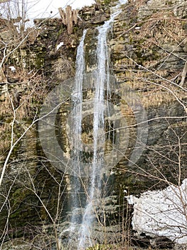 An unnamed waterfall in the canyon of the Fallenbach alpine stream above the Lake Walen or Lake Walenstadt Walensee, Amden