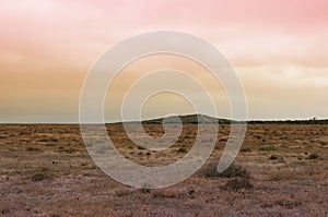 Unnatural arid landscape with weird sky color