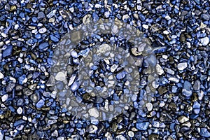 Unnatural world. Blue beach pebbles. Stones and gravel used as d