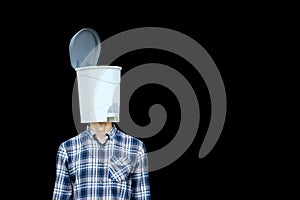 Unnecessary useless knowledge, information pollution concept. Man with trash bin for a head on black background. Contemporary photo