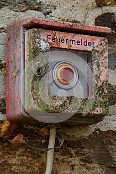 Unneeded old fire alarm box with lichen and rust