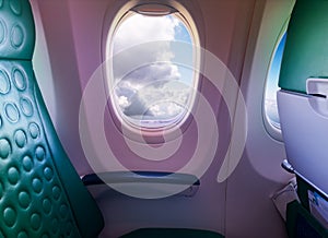 Unoccupied seat near the window in a plane with clouds