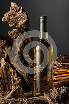 Unopened bottle of white wine and dried old snags photo