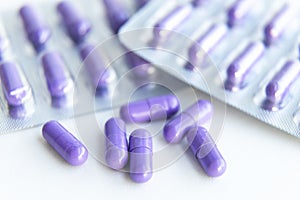 Unpacked antibiotic tablets and capsules in blisters