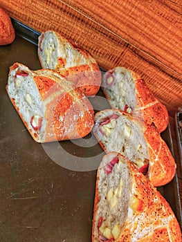 Unpacked meat and cheese sandwiches on the pan