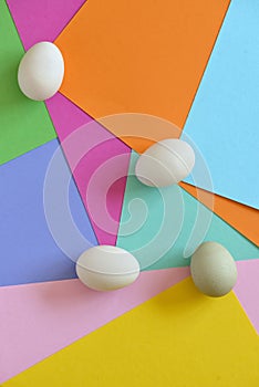 Unpainted eggs on color papers