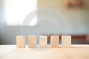 unpainted wooden cubes arranged in a row