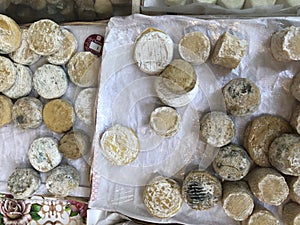 Unpasteurized french cheese on display at a farmer`s market.