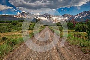 Unpaved county roads towards Rocky Mountains Range in Colorado, USA