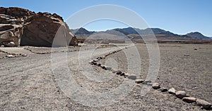 Unpaved road near Ancient Petroglyphs on the Rocks at Yerbas Buenas in Atacama Desert in Chile