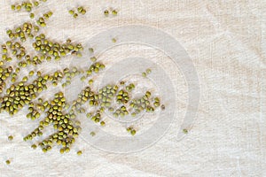 Unpeeled mung bean on linen fabric background