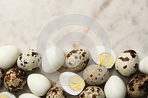 Unpeeled and peeled hard boiled quail eggs on light table, flat lay. Space for text