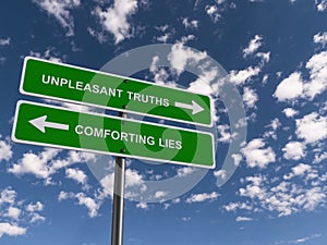 unpleasant truths comforting lies traffic sign on blue sky photo