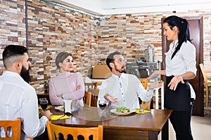 Unpleased client talking with manager in restaurant