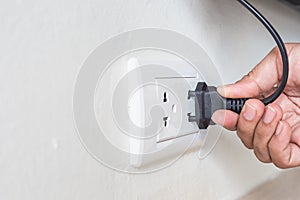 Unplug or plugged in concept,hand holding and pull electric plug