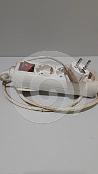 Unpluged electricity cord in white colour photo