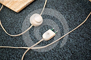Unpluged lamp cable on the carpet floor. Old lamp cable