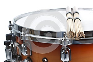 Unplugged drumsticks resting on a snare drum