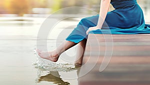 Unplugged Life or Human Living with Nature Concept. Young Woman Relaxing by Riverside