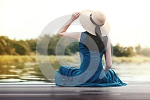 Unplugged Life and Relaxation Concept. Portrait of Young Woman Relaxing by Riverside.