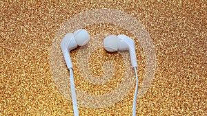 Unplugged white headphone golden background