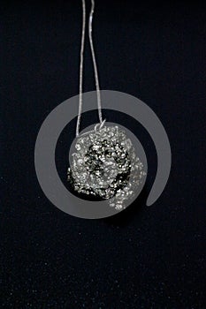 Pyrite gem, pyrite stone. Necklace on black background. Vertical imagem