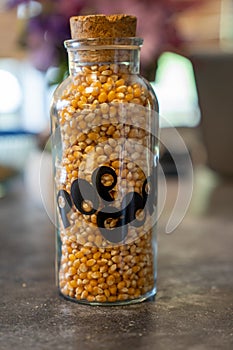 Unpopped Popcorn in vintage 1970s era glass jar with cork top.
